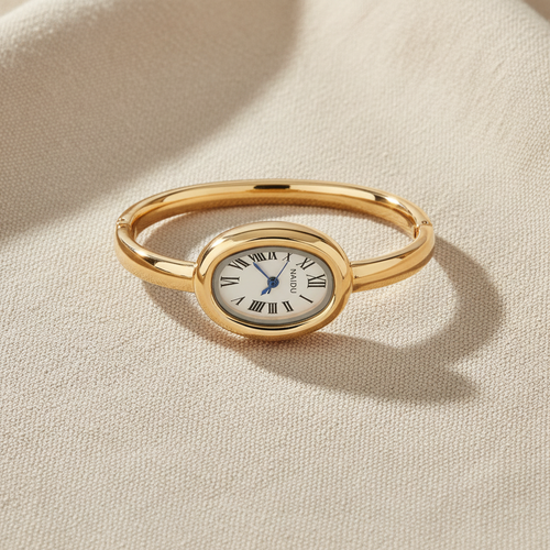 Reloj BANGLE ROMANO GOLD dorado con caja ovalada, carátula blanca con números romanos y brazalete bangle dorado